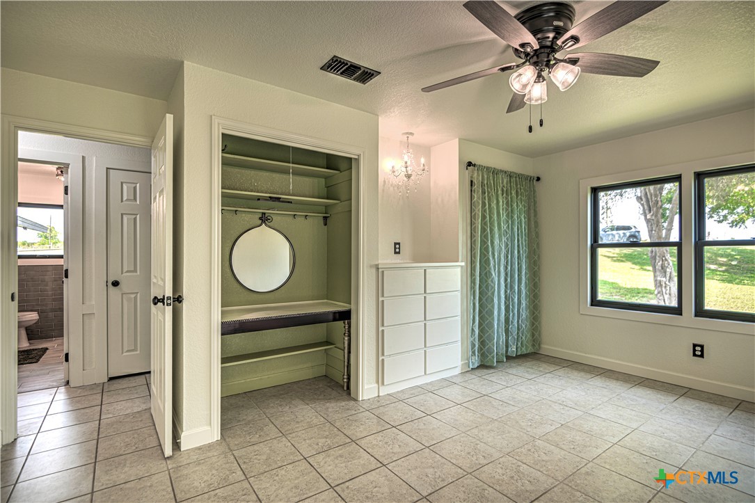 2810 FM 438 Loop Temple, TX 76501 - Photo 22 of 47 a view of a livingroom with a chandelier fan and windows