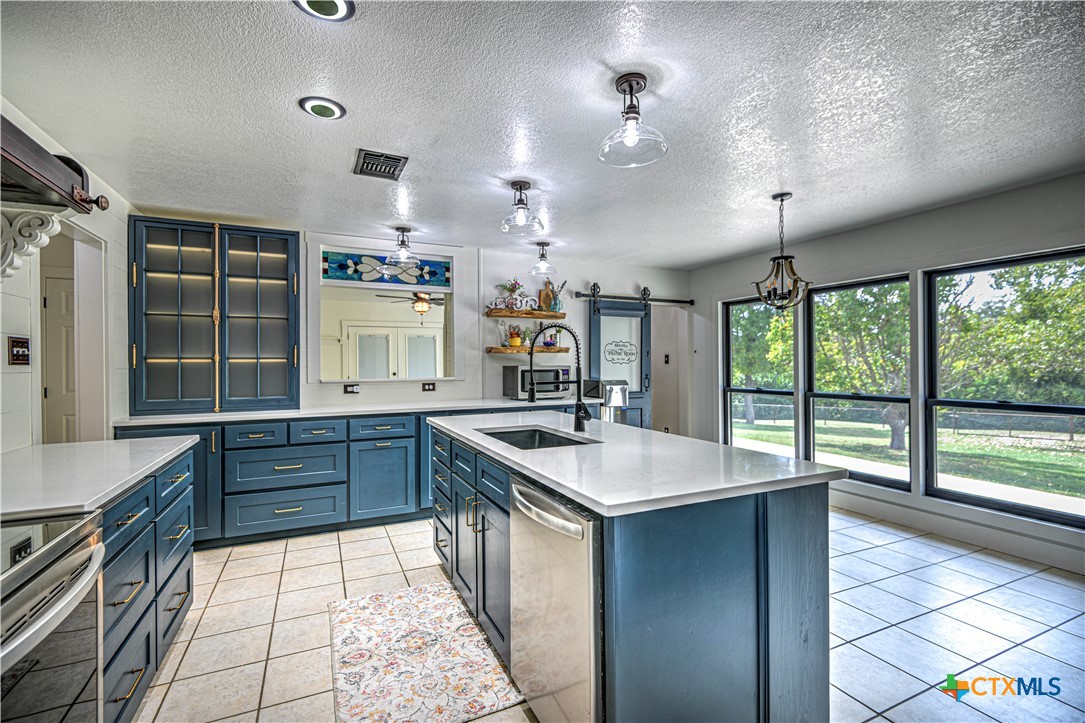 2810 FM 438 Loop Temple, TX 76501 - Photo 6 of 47 a kitchen with a sink stove and cabinets