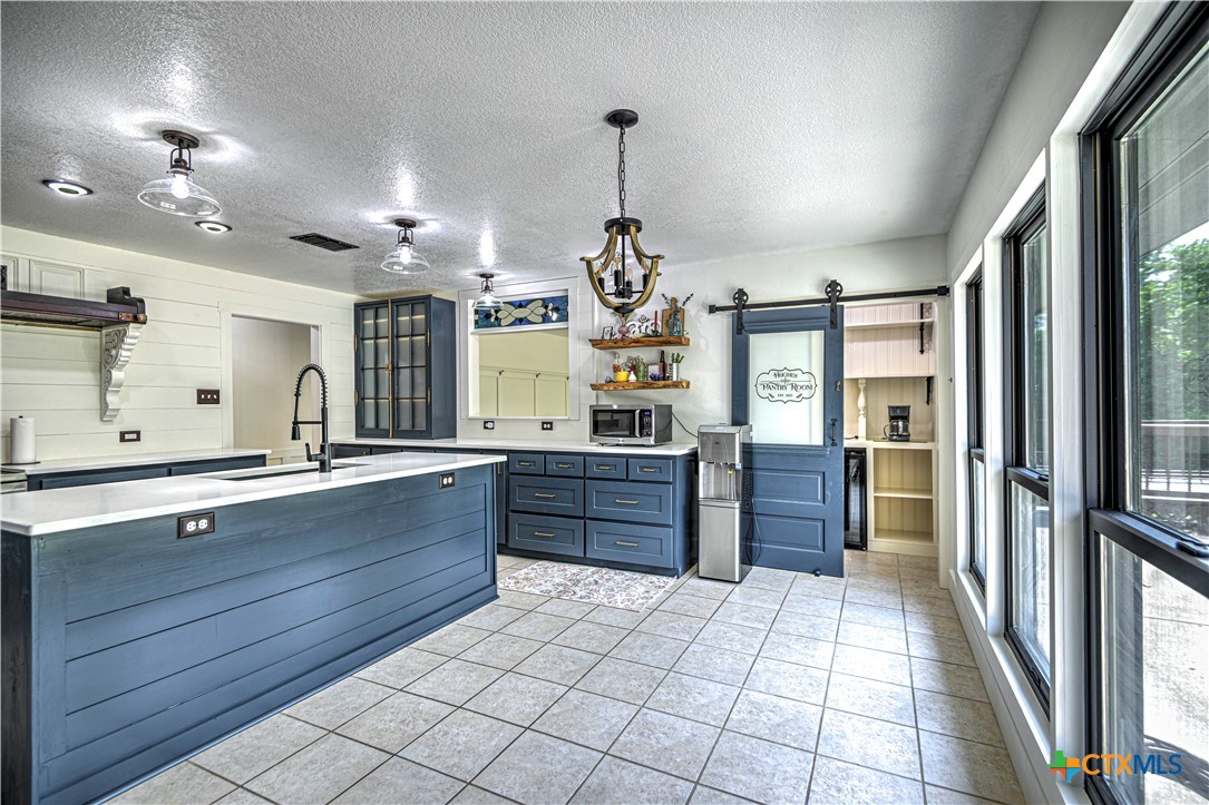 2810 FM 438 Loop Temple, TX 76501 - Photo 7 of 47 a large kitchen with a large counter top space a sink stainless steel appliances and cabinets