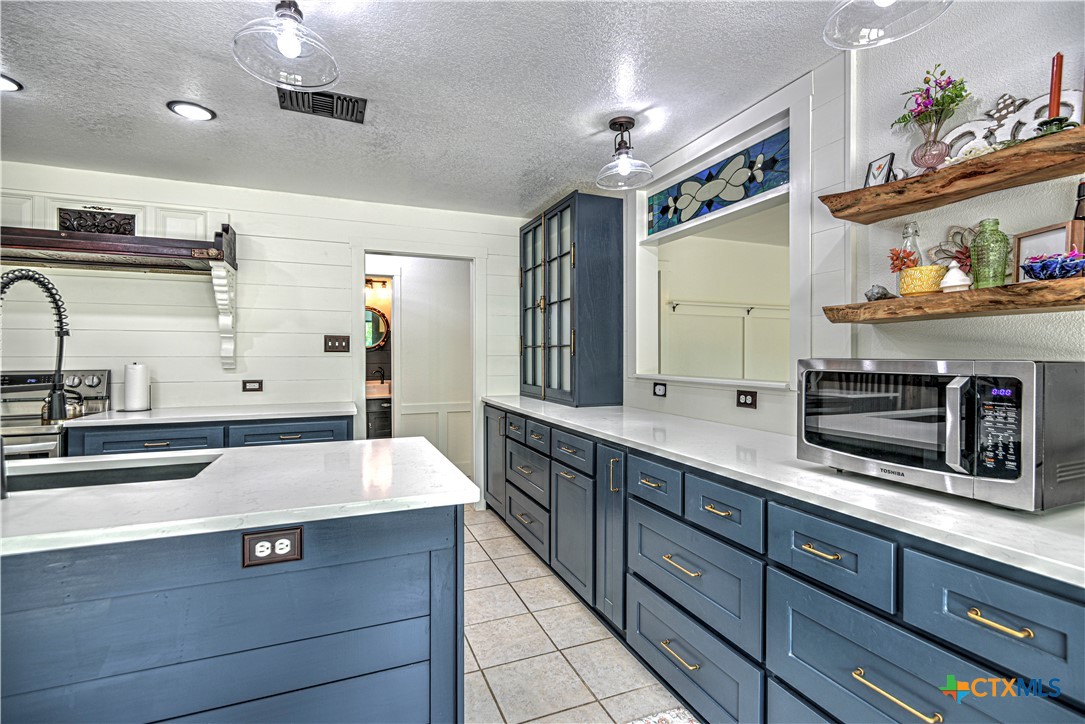 2810 FM 438 Loop Temple, TX 76501 - Photo 10 of 47 a kitchen with stainless steel appliances a sink stove and cabinets
