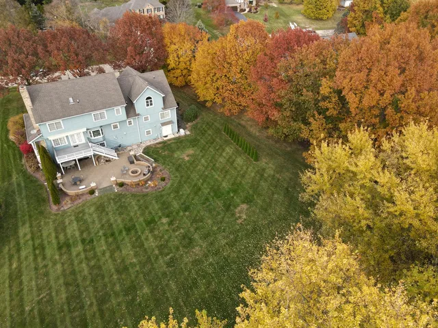 an aerial view of a house with swimming pool and big yard