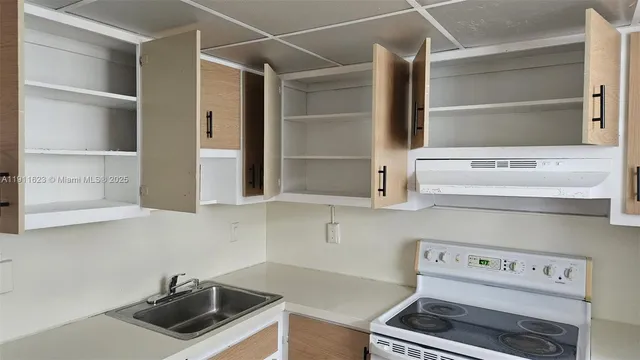 a kitchen with a cabinets and a stove top oven