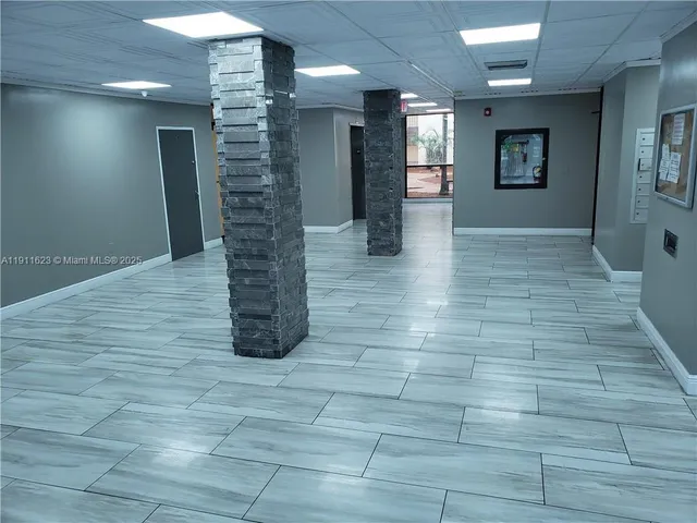 a view of a hallway with seating space