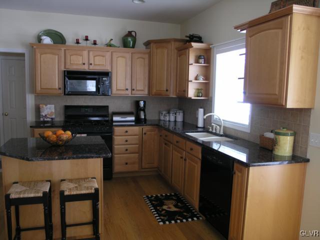 2128 Terry Road Nazareth, PA 18064 - Photo 6 of 15 a kitchen with granite countertop a sink stove and cabinets