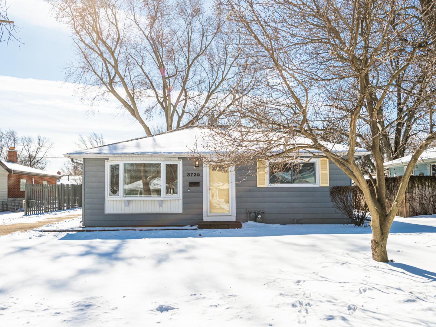 3725 Bluebird Lane Rolling Meadows, IL 60008 - Photo 1 of 1 a front view of a house with a yard covered in snow