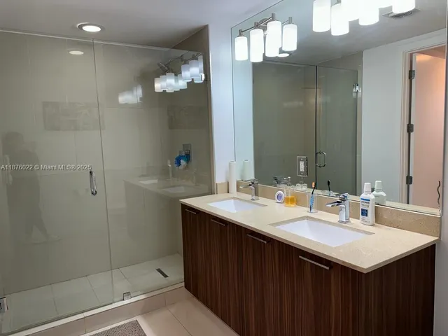a bathroom with a sink double vanity and a mirror