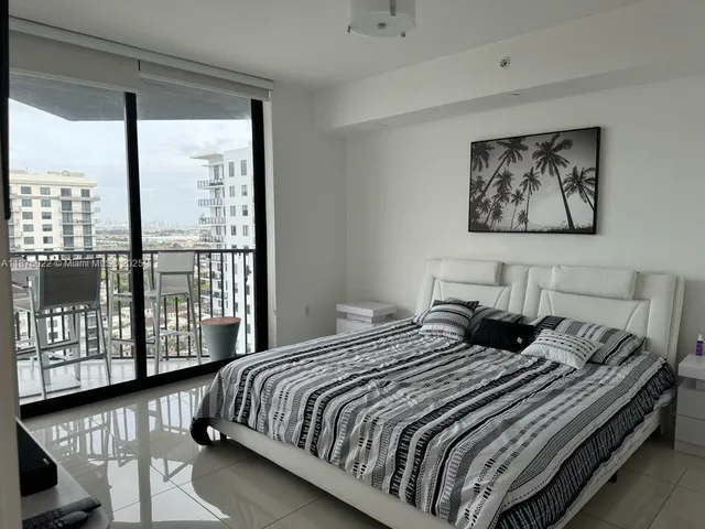 a bedroom with a bed and glass window