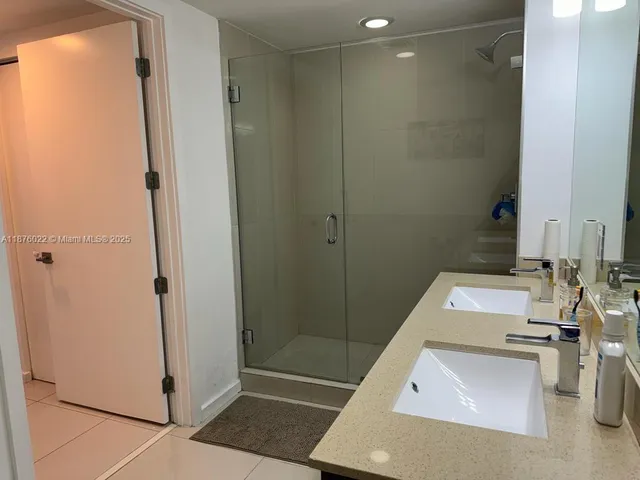 a bathroom with a sink and a shower