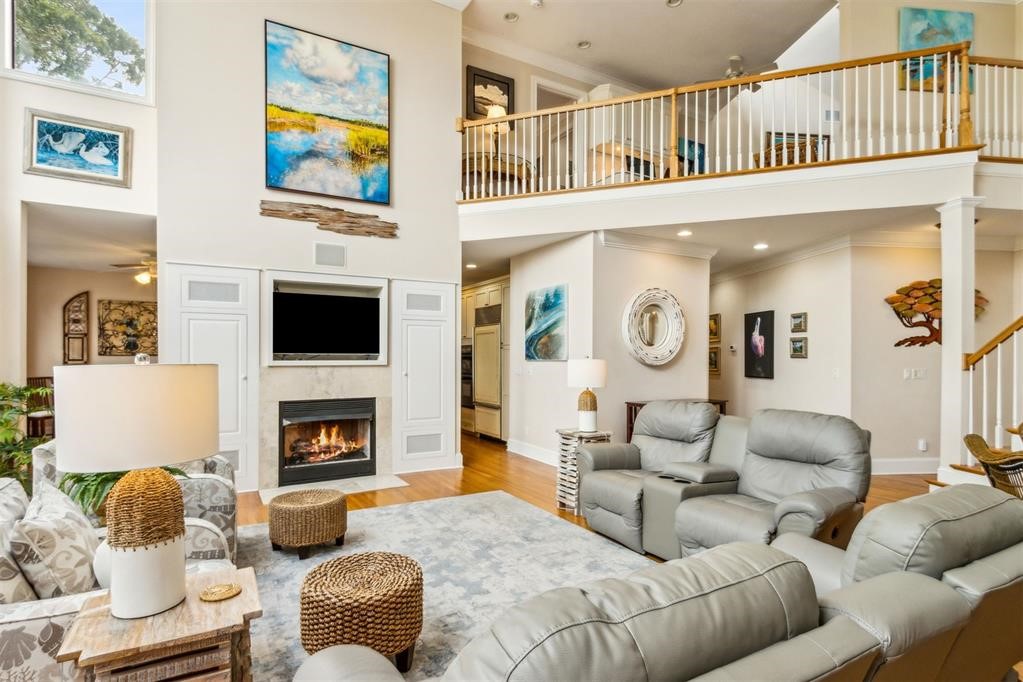 3119 Sea Marsh Road Fernandina Beach, FL 32034 - Photo 11 of 41 a living room with furniture a flat screen tv and a fireplace