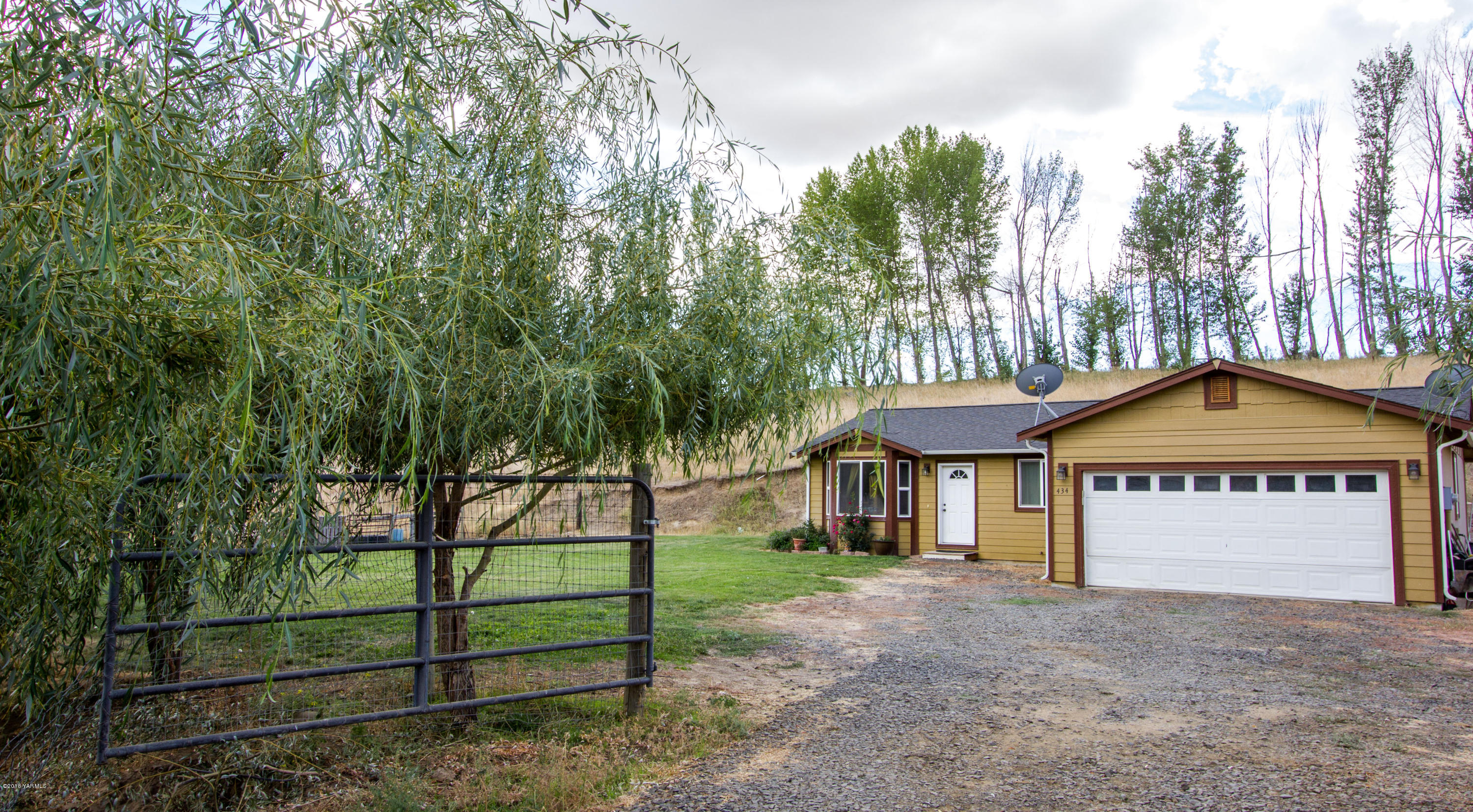 434 West Canyon Road Yakima, WA 98908 - Photo 4 of 23 a view of a house with a yard and large trees
