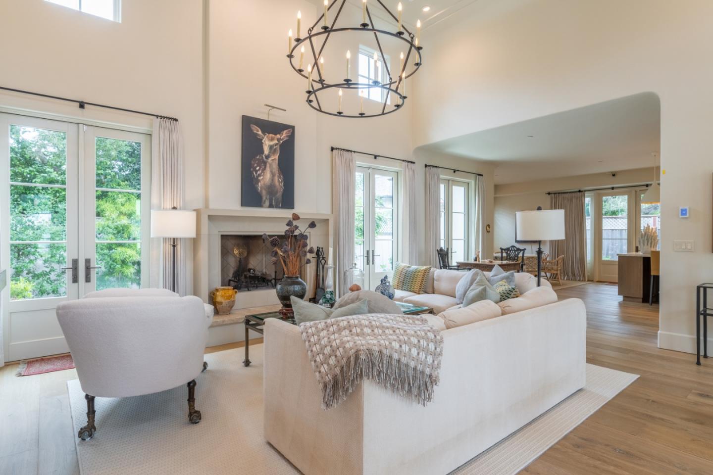1041 Rodeo Road Pebble Beach, CA 93953 - Photo 3 of 18 a living room with furniture a fireplace and a chandelier