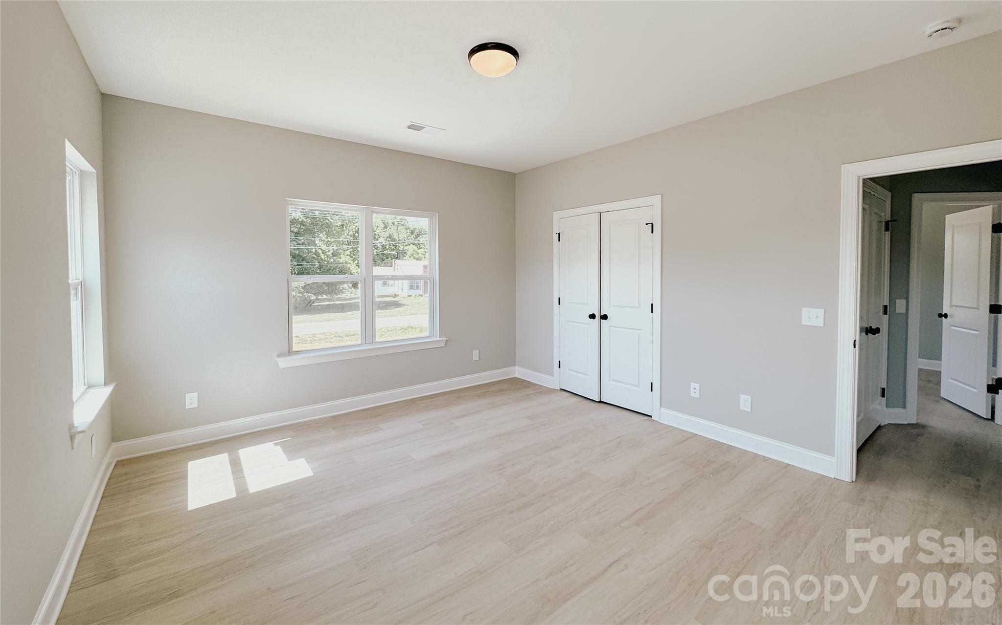 1455 West Ridge Road Salisbury, NC 28147 - Photo 15 of 26 a view of an empty room with wooden floor and a window