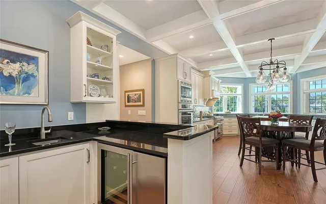 a kitchen with stainless steel appliances granite countertop a stove a refrigerator and a kitchen island