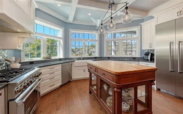a bedroom with a large bed couch and a large window