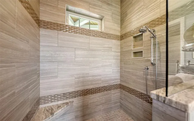 a bathroom with a granite countertop sink mirror vanity and toilet