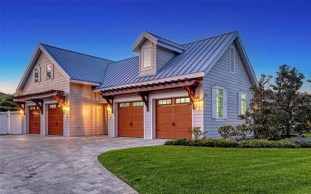 a front view of a house with a garden and yard