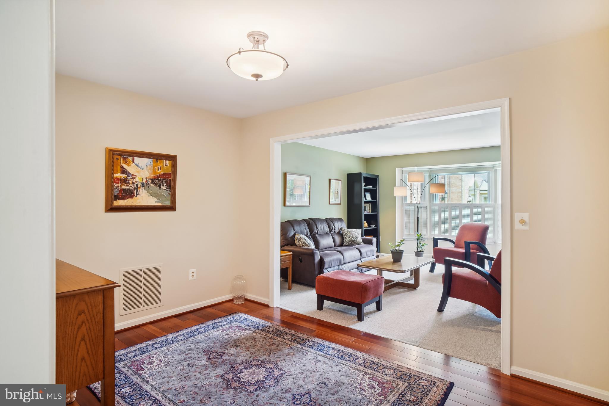 1049 Windrush Lane, Unit 2 Sandy Spring, MD 20860 - Photo 15 of 59 a living room with furniture and wooden floor