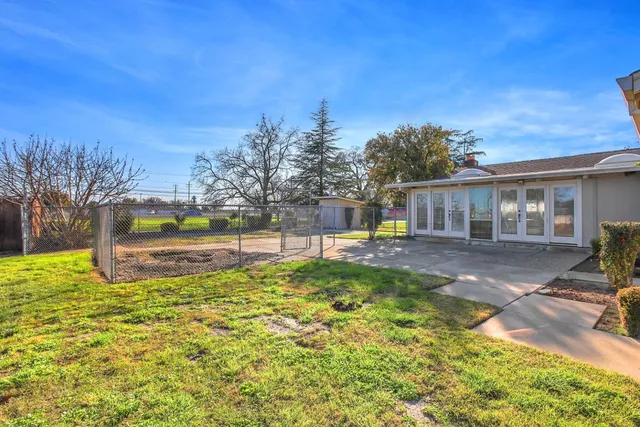 a kitchen with cabinets appliances a sink and a refrigerator