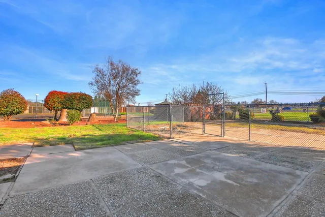 a kitchen with cabinets stainless steel appliances and wooden floor