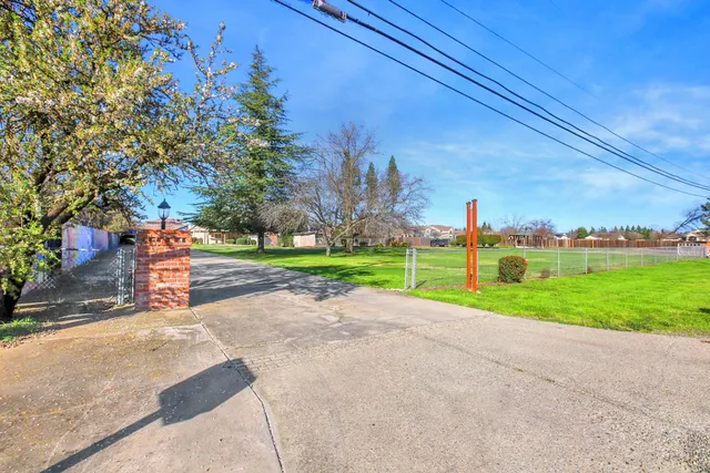 a view of a swimming pool with a yard