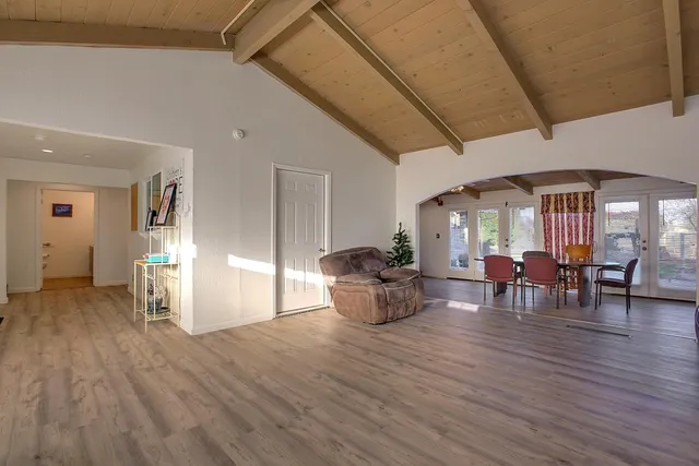 a view of a livingroom with furniture and an entryway
