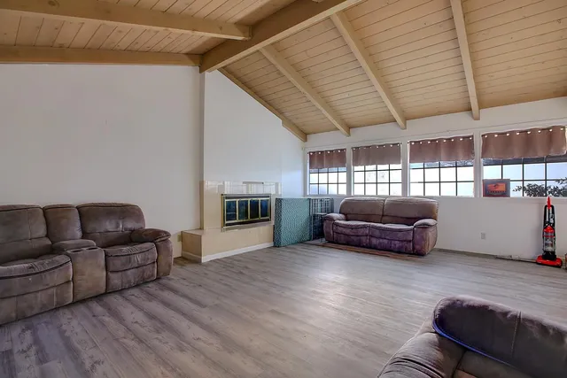 an empty room with a ceiling fan and window