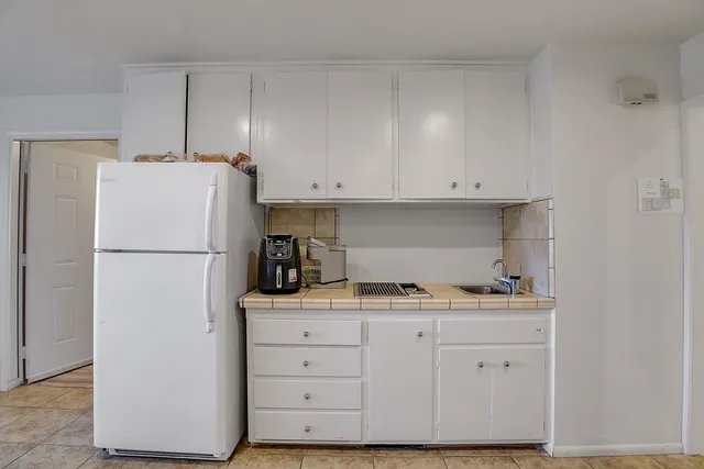 an aerial view of a house with a garden and swimming pool