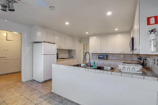 a view of a swimming pool with a garden and plants