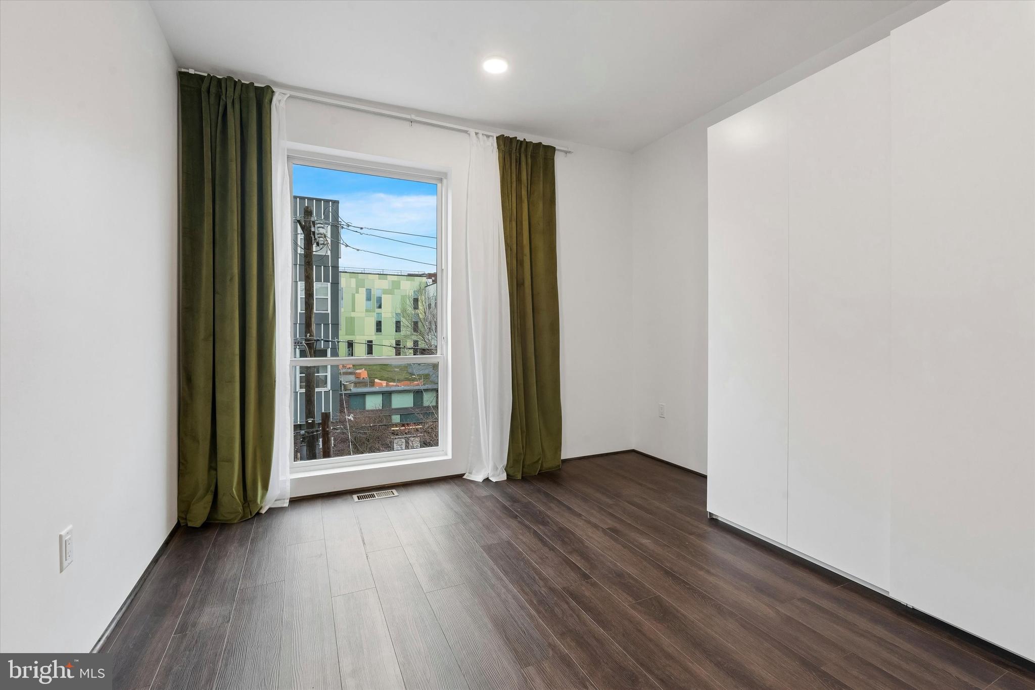1911 North 9th Street, Unit 2 Philadelphia, PA 19122 - Photo 12 of 18 an empty room with wooden floor and windows