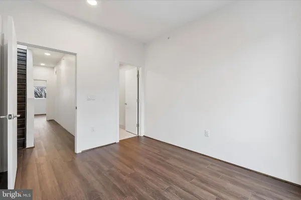 a view of a room with wooden floor