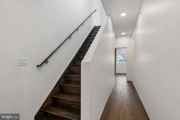 a view of entryway and gallery with wooden floor