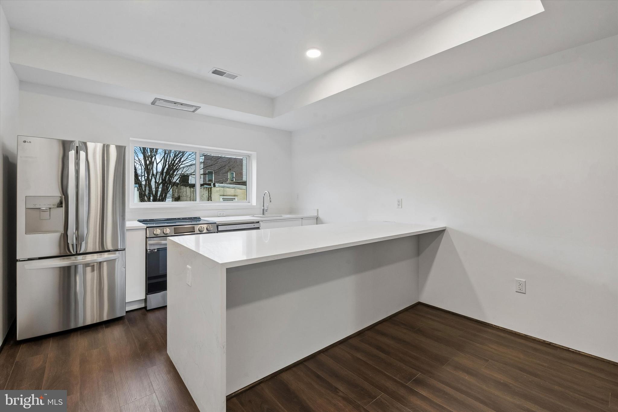 1911 North 9th Street, Unit 2 Philadelphia, PA 19122 - Photo 3 of 18 a kitchen with wooden floor and electronic appliances