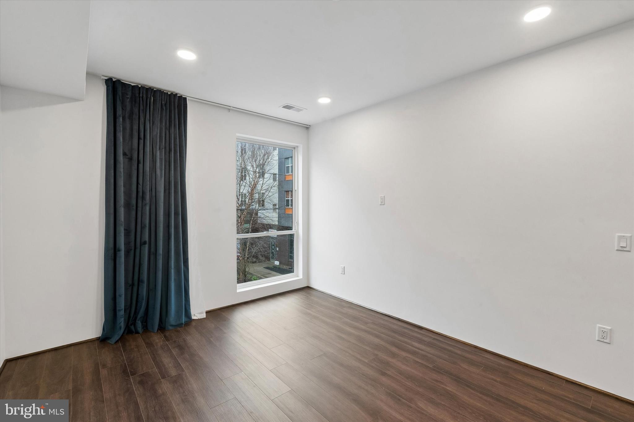 1911 North 9th Street, Unit 2 Philadelphia, PA 19122 - Photo 6 of 18 wooden floor in an empty room with a window