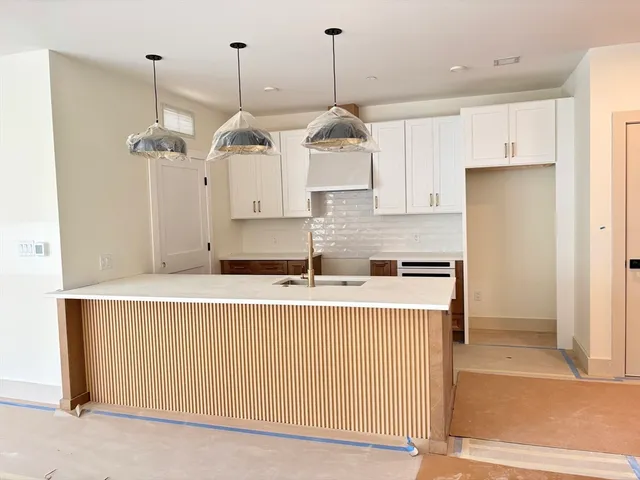 a kitchen with stainless steel appliances granite countertop a sink a refrigerator and a oven