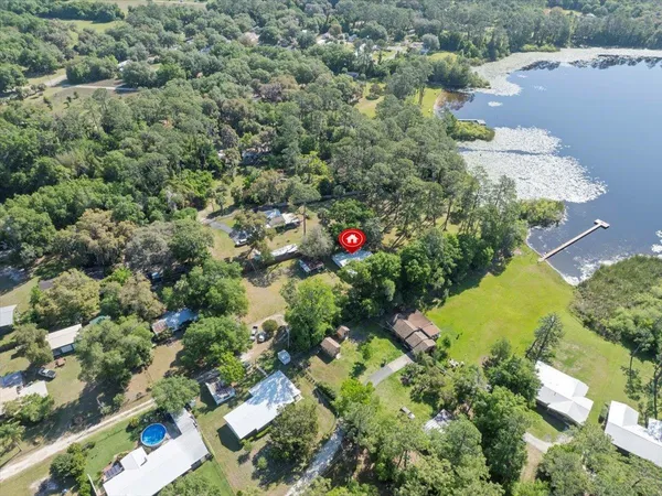 an aerial view of residential house with outdoor space and lake view