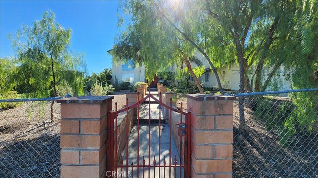 a view of a dining room with furniture a chandelier and wooden floor
