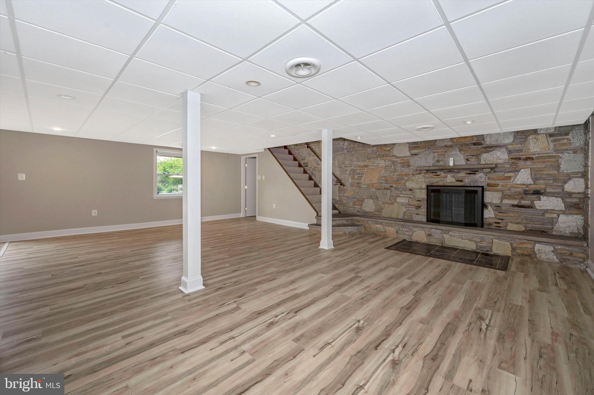 1724 Bollinger Road Westminster, MD 21157 - Photo 32 of 71 Lower level vinyl floors with stone fireplace
