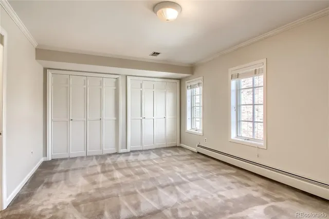 a bathroom with a granite countertop toilet and a sink