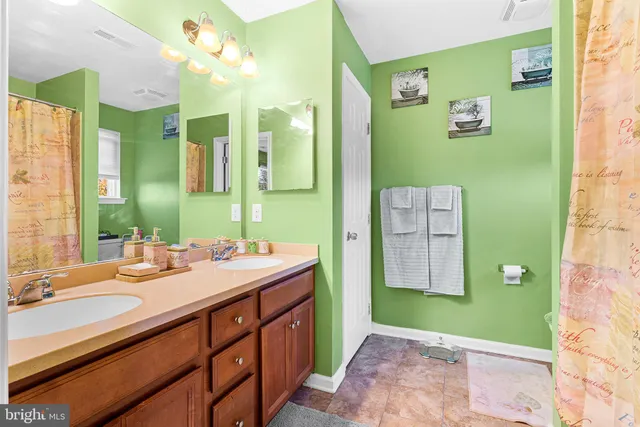 a bathroom with a sink a mirror and a shower