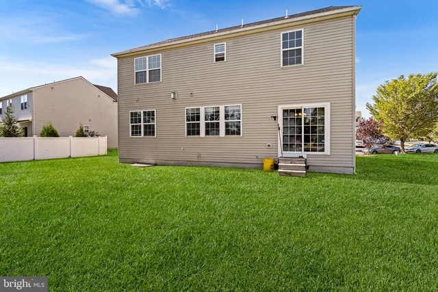 a view of house with backyard