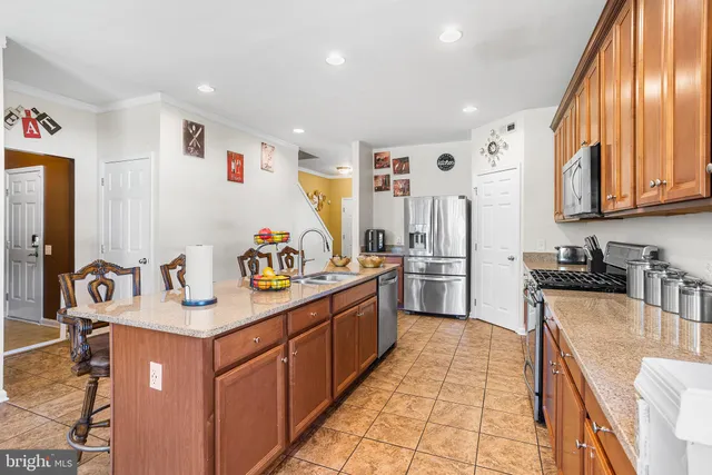 a kitchen with stainless steel appliances granite countertop a sink and cabinets