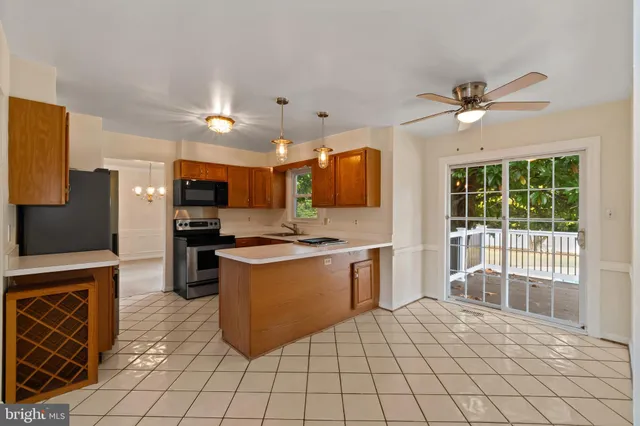a kitchen with stainless steel appliances granite countertop a stove top oven a sink a counter top space and cabinets