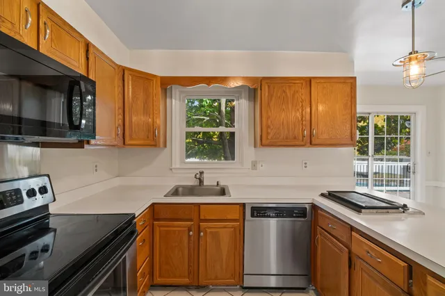 a kitchen with stainless steel appliances a sink stove and microwave