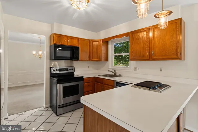 a kitchen that has a sink and a stove top oven