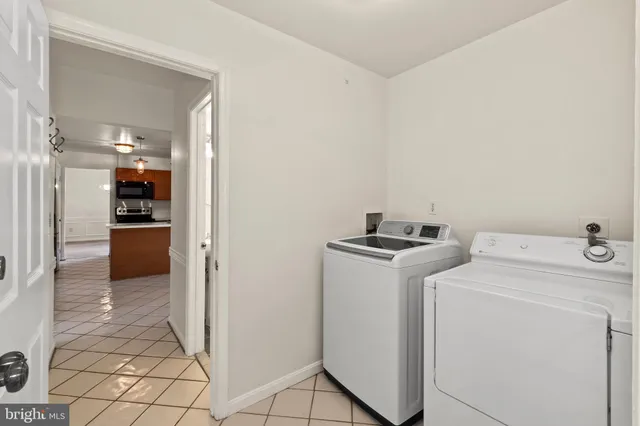a view of storage and utility room with washer and dryer