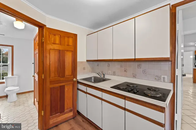 a kitchen with a sink and cabinets