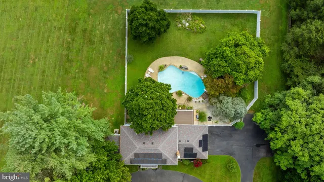 an aerial view of a house with a yard basket ball court and outdoor seating