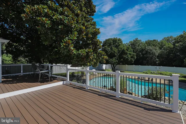 a balcony with wooden floor and fence