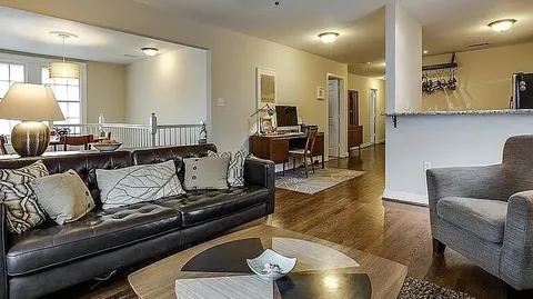 a living room with furniture and a lamp