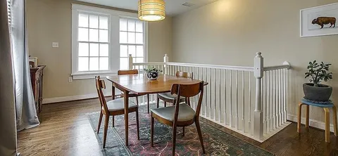 a view of a dining room with furniture and a window